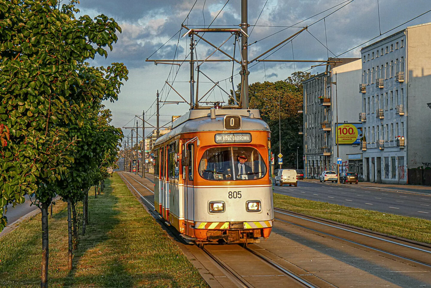 Na zdjęciu białopomarańczowy tramwaj lini turystycznej "0" jadący po torowisku. 