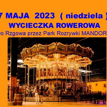 Plakat promujący wycieczkę rowerową do Rzgowa (przez Park Rozrywki Mandoria) - niebieskie napisy na pomarańczowym tle. Zdjęcie karuzeli.
