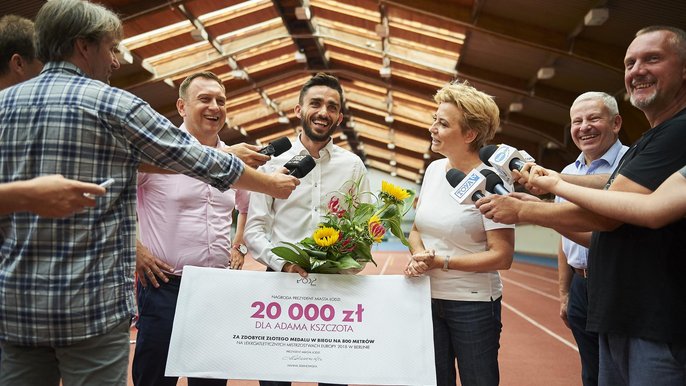 Adam Kszczot zdobył złoty medal za pierwsze miejsce w biegu na 800 m. Za to osiągnięcie odebrał symboliczny czek na 20 tys. zł. - fot. Radosław Jóźwiak / UMŁ