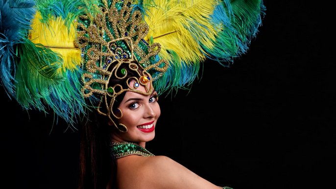 Brazilian woman posing in samba costume over black background 